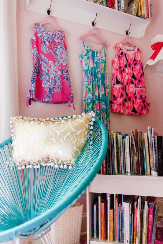 A blue chair with a pillow on it in a room