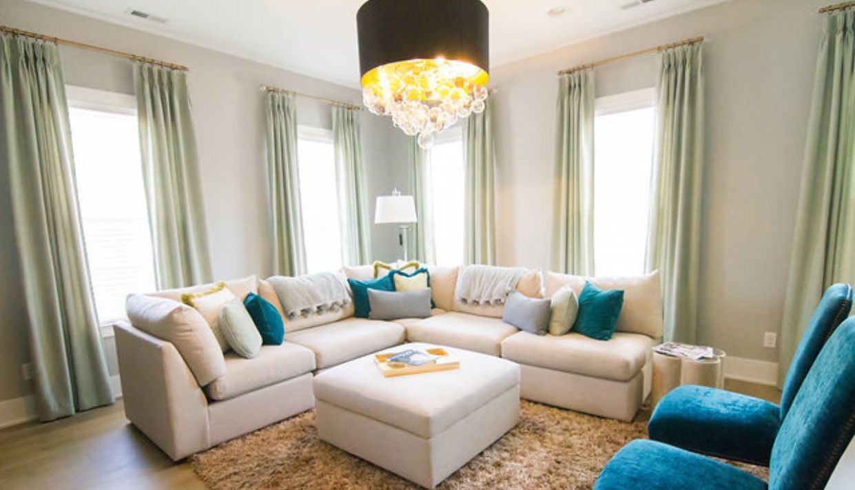 A living room filled with furniture and a chandelier.