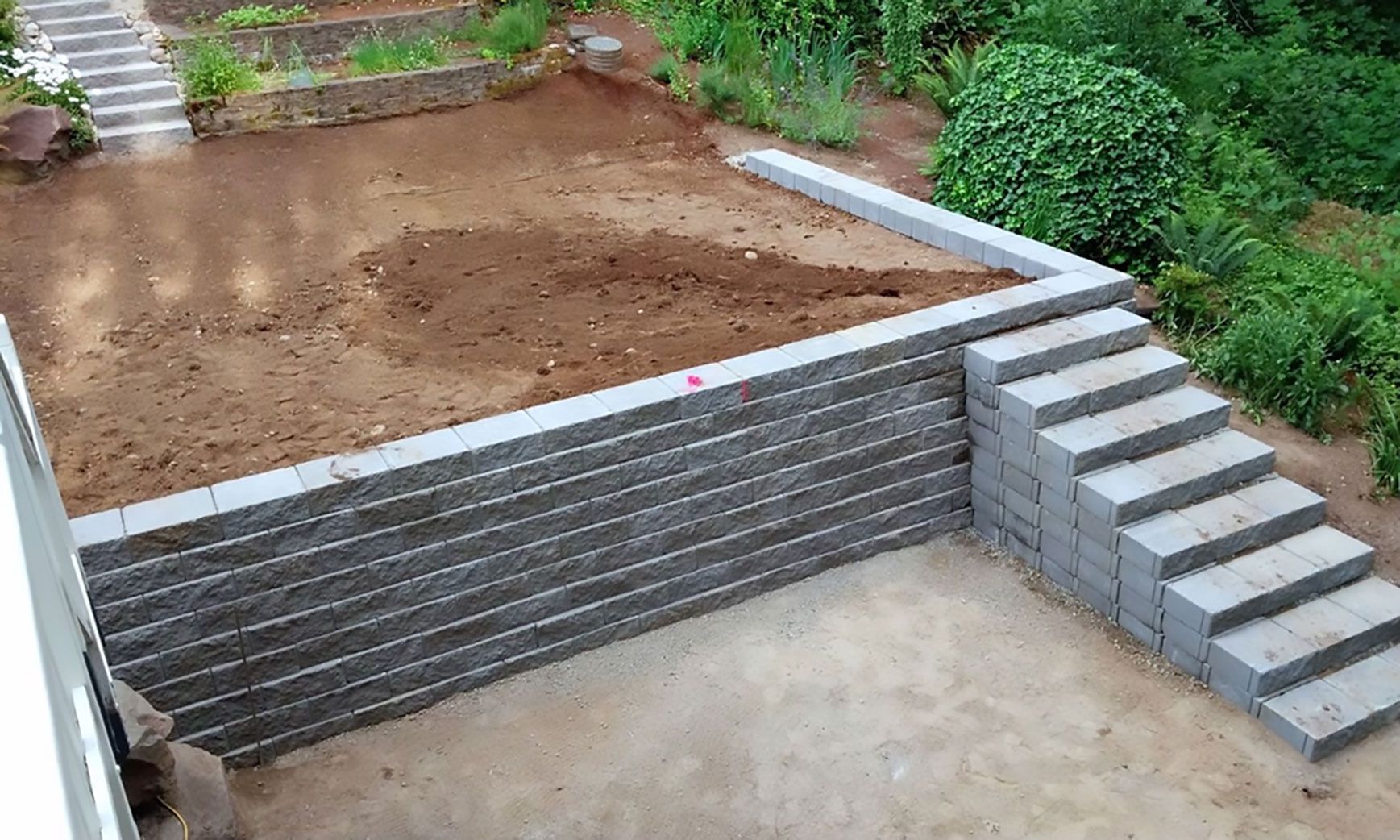 A brick wall with stairs leading up to it