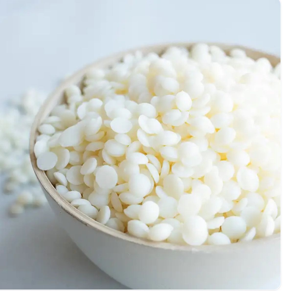 Bowl of white wax beads.