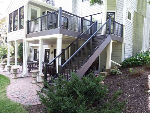 A house with a deck and stairs leading up to it