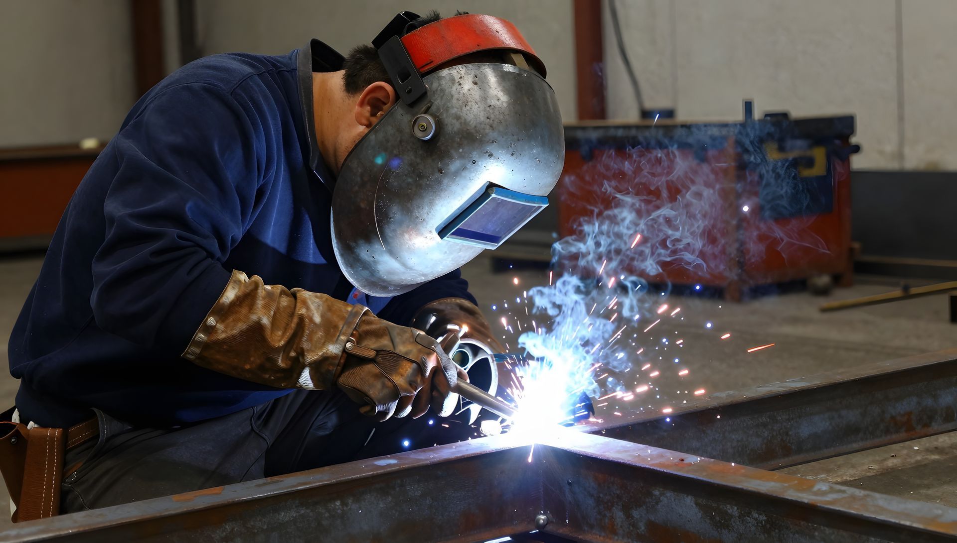 Professional welder works on metal construction with sparks and smoke in the factory.