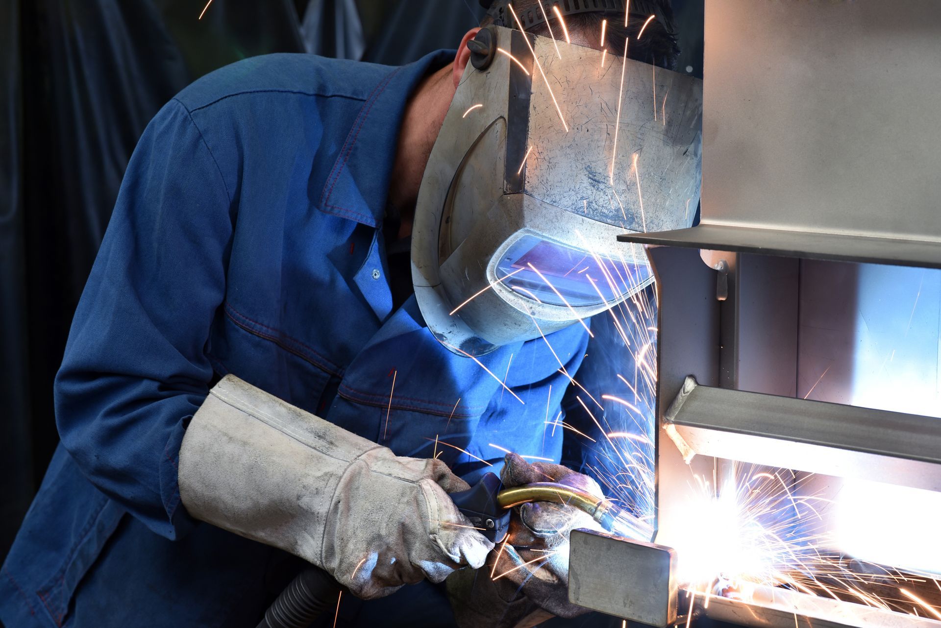 A man is working as a welder.