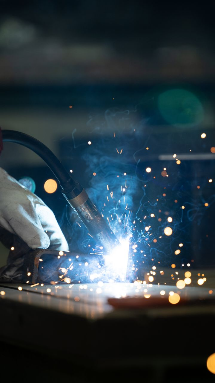 Close-up of welding sparks during residential ironworks fabrication. Close-up of welding sparks during residential ironworks fabrication.