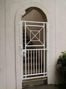 A white gate leading to a set of stairs