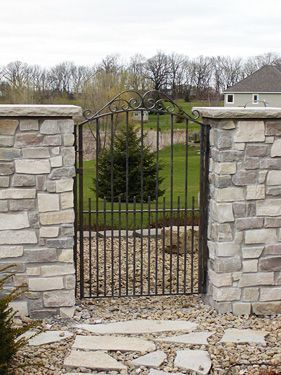 A stone wall with a gate in the middle of it