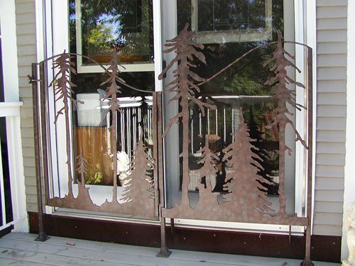 A wrought iron gate with a picture of trees on it