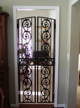 A door with a wrought iron gate on it