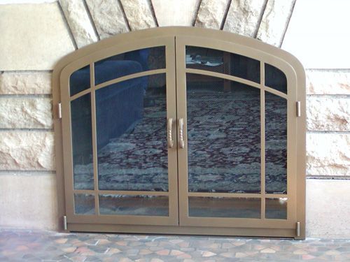 A large arched window with a brick wall behind it