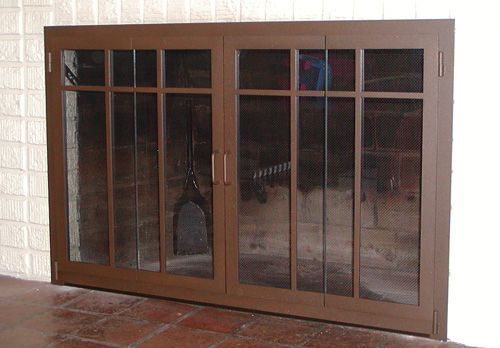 A fireplace screen with a brick wall behind it