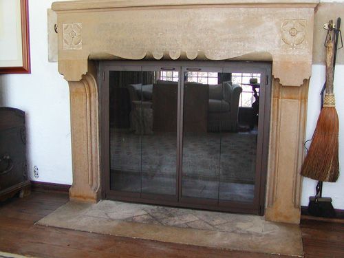 A living room with a fireplace and a broom