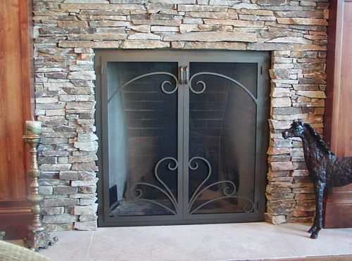 A fireplace with a horse statue in front of it