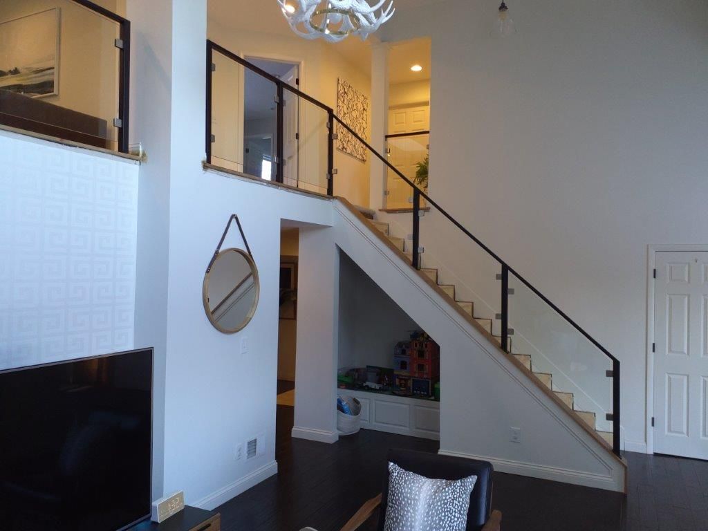 A living room with stairs leading up to the second floor