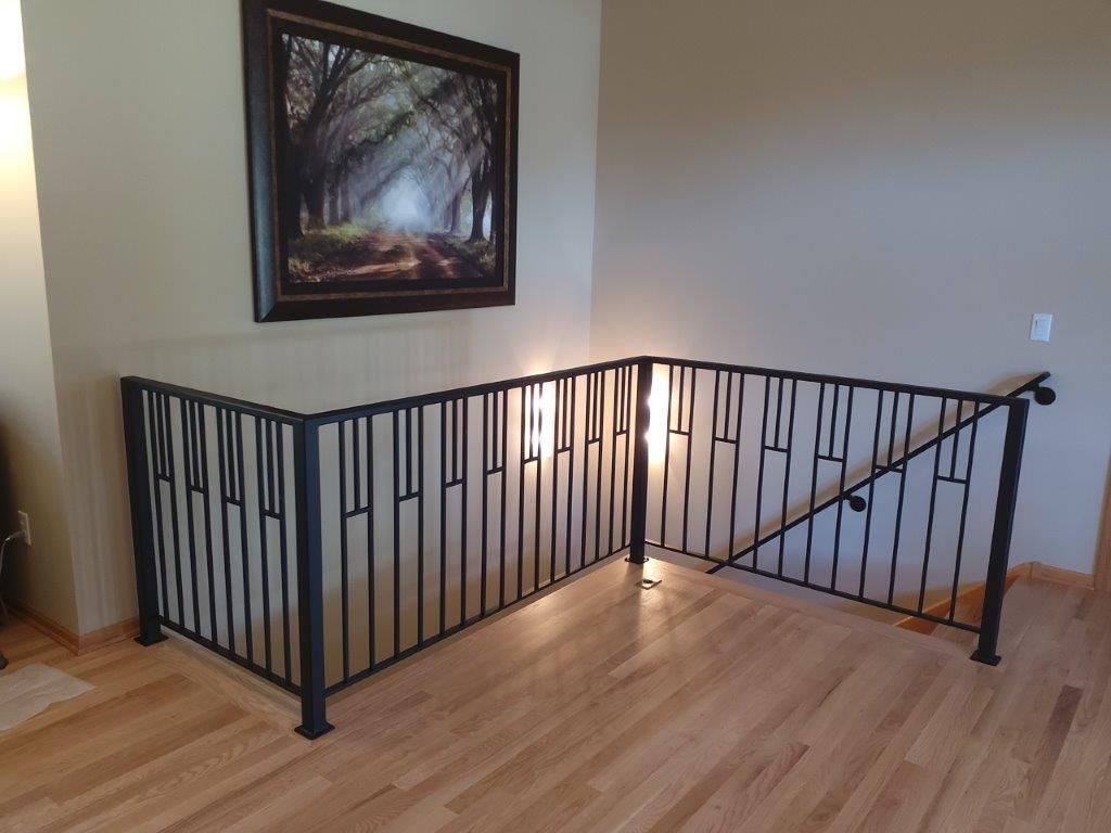 There is a picture on the wall above the railing.