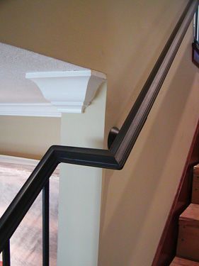 A close up of a railing on a staircase in a house.