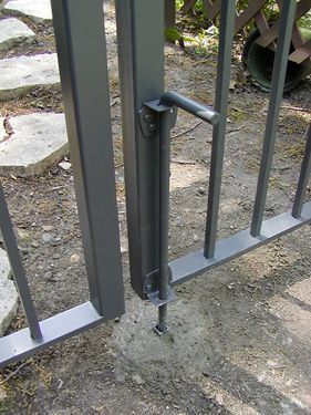 A close up of a metal gate with a handle on it.