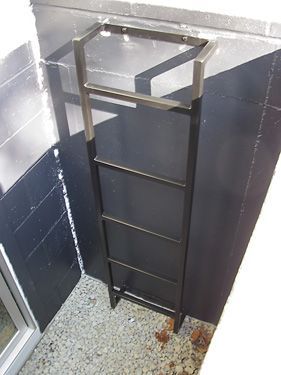 A ladder is hanging from the side of a building