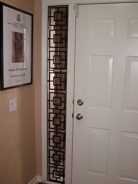 A white door with a picture on the wall behind it.