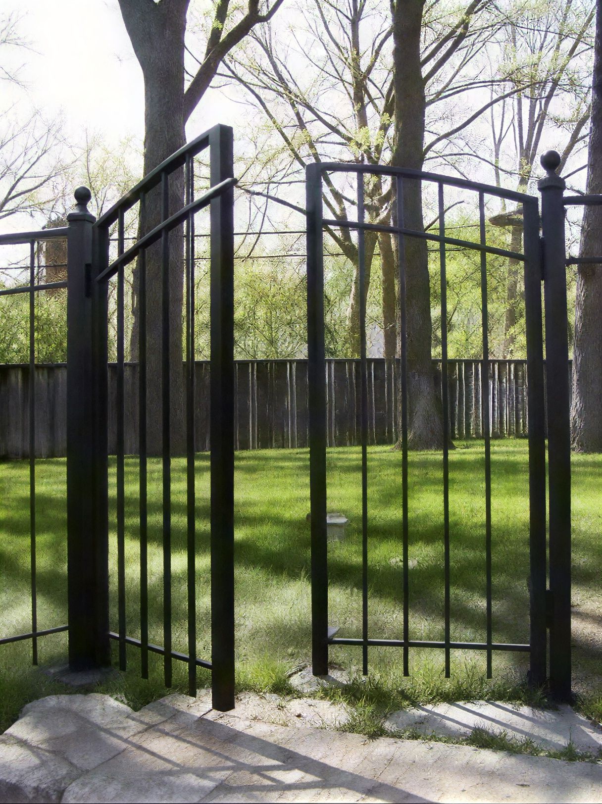 An ornamental aluminum fence gate.