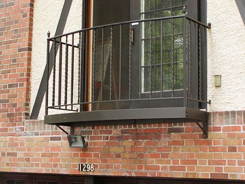 A balcony on the side of a brick building