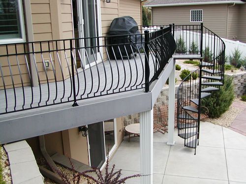 A balcony with a spiral staircase leading up to it