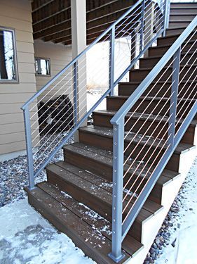 A set of wooden stairs with a metal railing