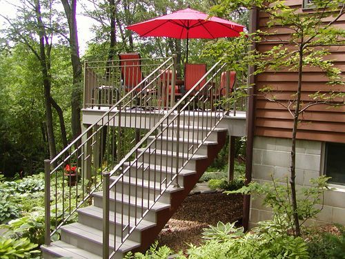 Stairs leading up to a deck with a red umbrella