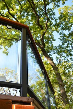 Looking up at a balcony with trees in the background