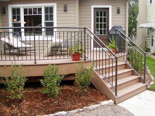 A house with a deck and stairs leading up to it