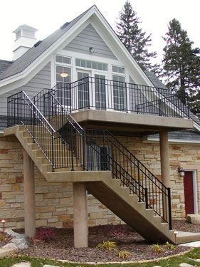 A house with a balcony and stairs leading up to it
