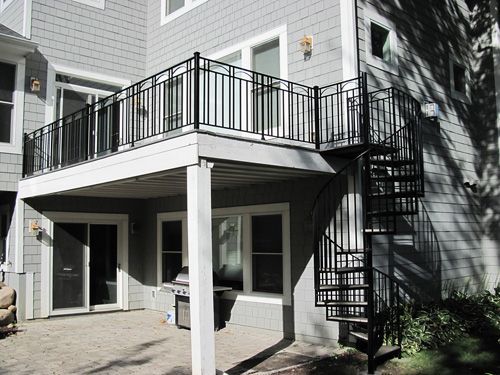 A house with a spiral staircase and a balcony