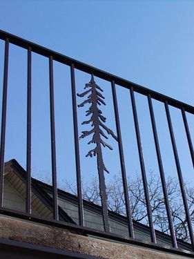 A railing with a silhouette of a tree on it
