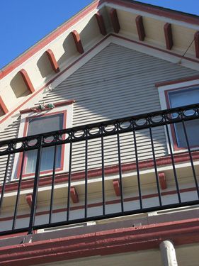 Looking up at a house with a black railing