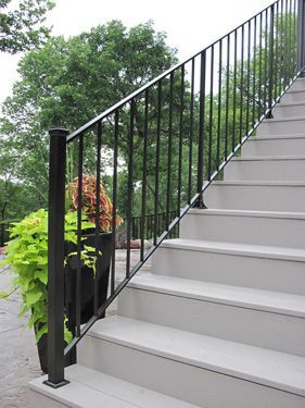 A staircase with a black railing and white steps