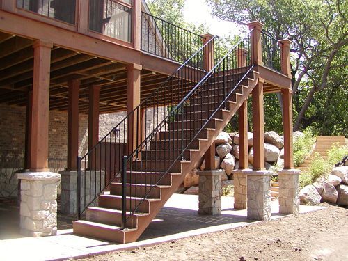 A wooden deck with stairs leading up to it