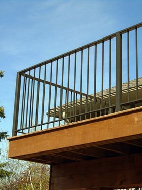 A wooden deck with a metal railing on it