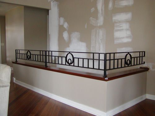 A staircase with a wrought iron railing in a living room