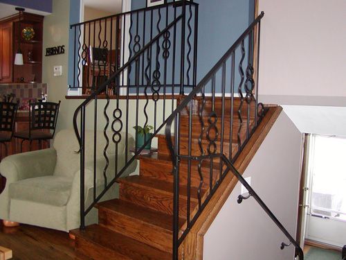 A staircase with a wrought iron railing in a living room
