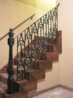 A set of stairs with a wrought iron railing
