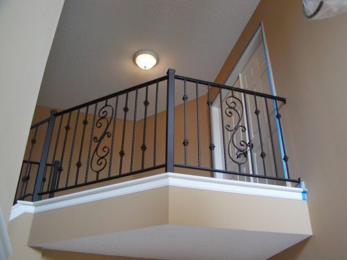 A balcony with a wrought iron railing in a house