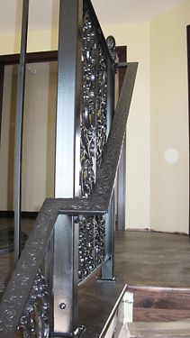 A close up of a black railing on a set of stairs.