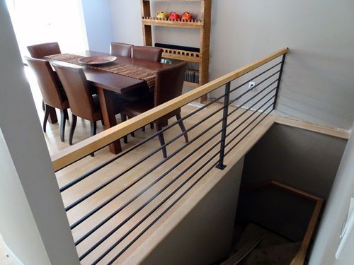 A staircase leading to a dining room with a table and chairs