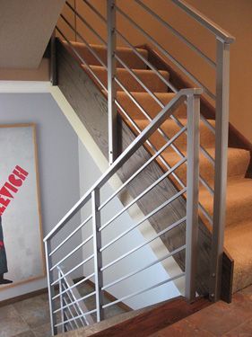 A staircase with a metal railing and a sign that says service