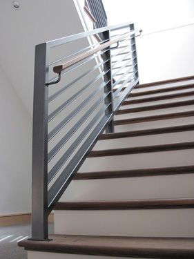 A staircase with a metal railing and wooden steps