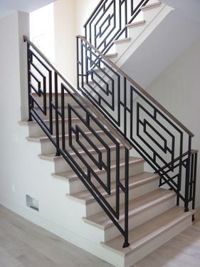 A staircase with a black railing and white steps