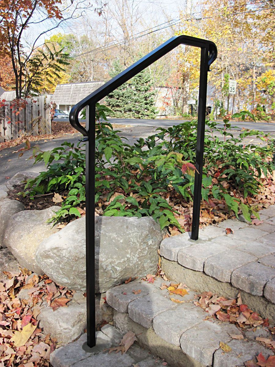 A wrought iron railing on the side of a house