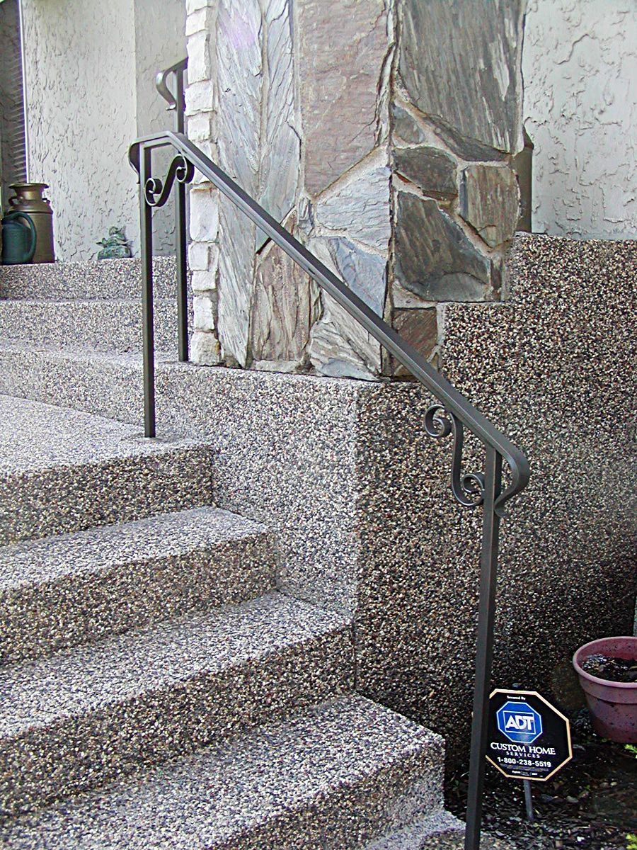A set of stairs with a railing and snow on them
