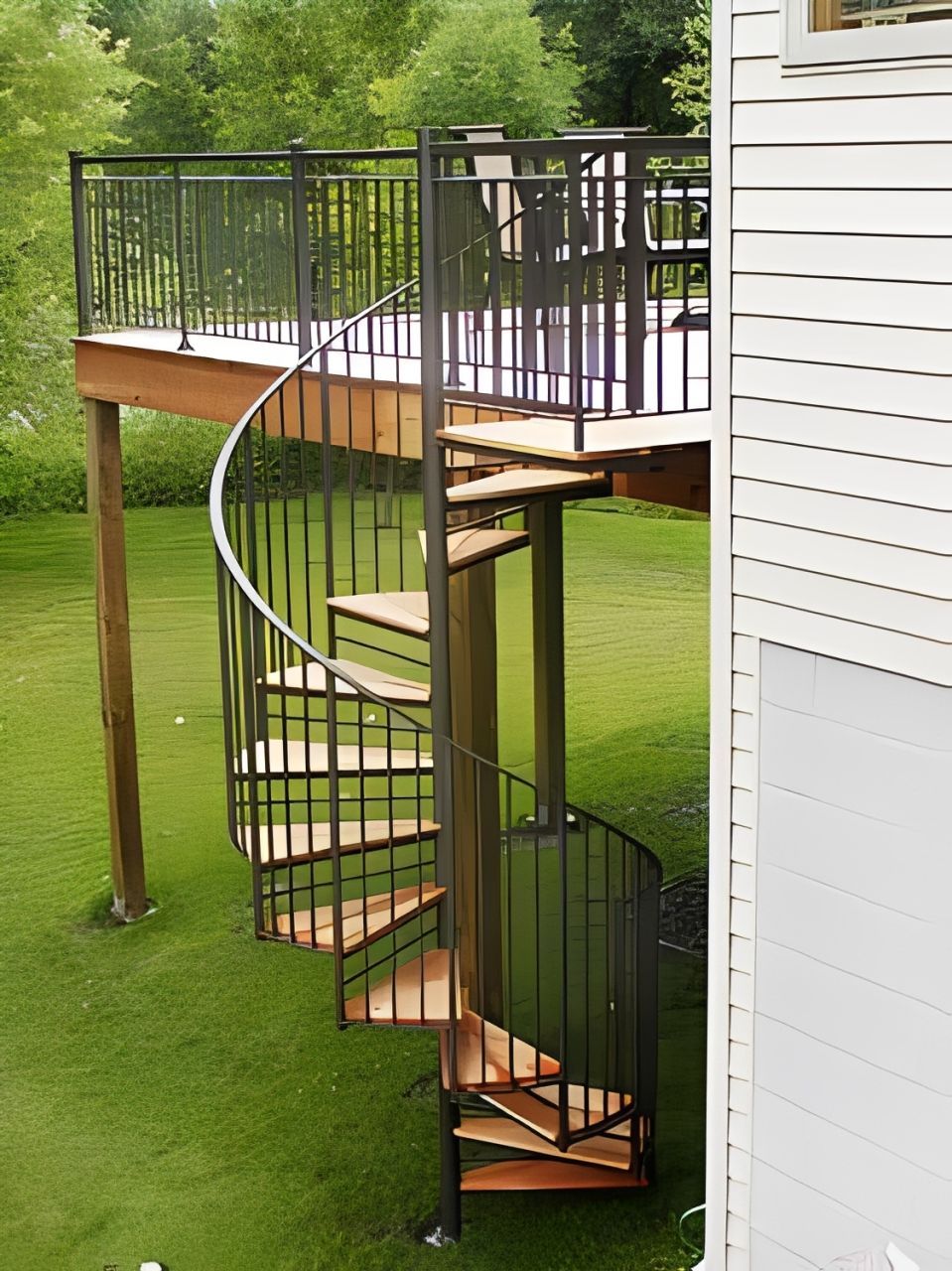 A black exterior spiral staircase with wood treads. A black exterior spiral staircase with wood treads.
