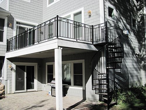 A house with a spiral staircase and a balcony