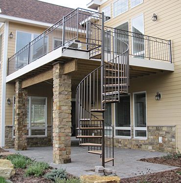 A house with a spiral staircase on the deck
